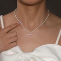 Elegant silver necklace with pink round-cut gemstone pendant worn on a female model - Silver Pink Gemstone Solitaire Necklace