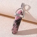 Macro shot of pink and black natural stone hexagonal point pendant with silver clasp - Rhodonite