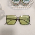Modern oval sunglasses with translucent grey frame and vibrant yellow-green lenses - Green 3