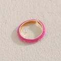 Pink enamel and gold ring with clear zircons on textured beige background - Rose Red
