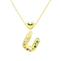 Detailed shot of a gold heart charm and letter U pendant set with colorful zirconia - Letter-U