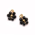 Detailed macro view of handmade gold stainless steel flower charms with black faceted beads - Black