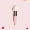 Detailed view of makeup sponge with teardrop head and ergonomic light pink handle - Single Pack / Rose Gold Tube + Beige Slanted Head