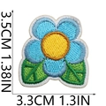 Close-up of blue flower embroidered patch with size markings 3.5cm by 3.3cm on white backdrop - No. 24 Blue Flower