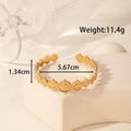 Adjustable wide gold stainless steel leaf cuff bracelet with textured sunburst relief - Sun Pattern Relief
