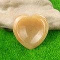 Polished yellow crystal heart worry stone for thumb healing on natural background - Yellow Jade