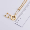 Two-tone titanium steel jewelry set with round earrings and necklace next to a ruler - Gold (Necklace + Earrings)
