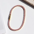 Elegant gold tennis bracelet featuring round pink cubic zirconia stones with a fold-over clasp - Gold Base-Pink Zirconia