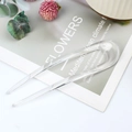 Transparent acrylic U-shaped hair pin for bun styling on a minimalist magazine background - Crystal Clear