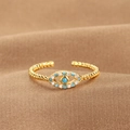 Adjustable gold evil eye ring with blue stones on a luxury brown silk background - Evil Eye Wavy Band (Q-J075) / Gold