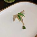 Detailed macro of gold bamboo brooch with green enamel leaves, pearl and emerald drop - Pendant Bamboo Pearl
