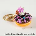 Purple donut keychain with chocolate layer, blue gemstone decoration and 4.5cm diameter - D12 Purple with Purple Cream Flower - Gold 8-clasp