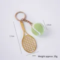 Miniature green tennis ball and golden racket keychain set with size dimensions - 2.5cm Large Light Green Tennis Ball + Gold Racket