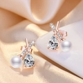 Elegant rose gold stud earrings featuring a teardrop zircon and round pearl accent - Rose Gold Crossed Pearl Stud Earrings (C20)