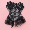 Close-up of floral lace texture and layered ruffle cuffs on black vintage wedding gloves - Kids One Size / Black