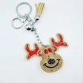 Close-up of reindeer keychain with red and black rhinestones, bell and beige tassel - Deer Head
