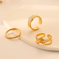 Three-piece gold stainless steel ring set with star and sun motifs on white ceramic - J571-Gold 3-Piece Set