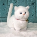 Realistic white plush toy cat with blue eyes, red collar and golden bell on a furry mat - White Chubby Cat With Sound
