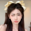 Elegant beige oversized pearl bow spring hair clip for sophisticated hair styling - Creamy Yellow Artificial Pearl Bow Spring Clip