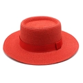 Detail view of woven red boater hat texture with matching ribbon and flat brim - Red