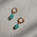 Detail of gold oval earrings with turquoise stones featuring black marbled textures - Blue Turquoise Oval Gold