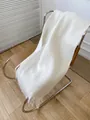 Thick warm white mohair knitted scarf for women with long fringe details on chair - Creamy White