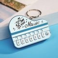 Miniature light blue piano keychain toy with numeric musical keys and music engraving - Bag Packaging / Sierra Blue