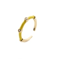 Close-up of gold-plated ring featuring yellow enamel and three inset clear crystals - Adjustable Open / Yellow