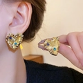 Golden heart-shaped stud earrings with colorful rhinestones on female ear - Gold Twisted Heart Earrings With Rhinestones (18#)