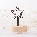 Star shaped metal memo holder with a round wooden base on a starry white tulle background - Pentagram