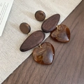Detail of vintage geometric earrings with amber resin heart and wood drop on linen - 63# Silver Earring Post-Brown-Wooden Heart Resin