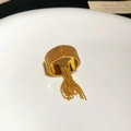 Detail of gold beaded open ring featuring a delicate hanging bead tassel on white surface - Gold