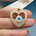 Detailed view of heart-shaped shell evil eye pendant with sparkling white zircons - Style C