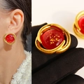 Vintage gold stud earring with oval red inlay and gold foil detail worn by model - Red Gold Foil Spiral Style (Style 5)