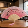 Pink gradient folding fan with plum blossoms and butterflies, bamboo frame with tassel - Style 37 (Face Like Peach Blossom) (New Style)