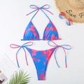 Flat lay of pink and blue camo string bikini set with beach vacation accessories - S / Blue