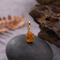 Detailed view of an S925 silver pear-shaped yellow gemstone pendant on a rustic rock - Natural Citrine Water Drop Pendant Gold
