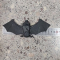 Black rubber Halloween bat pendant with red eyes and hanging string for spooky decor - Medium 18*6.5CM