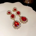 Elegant gold drop earrings with red gemstones and clear crystals on a cream plate - 50# Gold-Red-Flower Water Drop (925 Silver Pin)