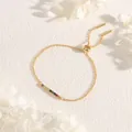 Detail of adjustable gold bracelet featuring rainbow cubic zirconia and slider clasp - Gold with Rainbow Zircon