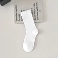 Minimalist white cotton mid-calf socks displayed on a book for a clean aesthetic look - One Size / White