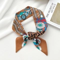 Caramel silk twilly with geometric flower prints tied in a bow as hair accessory - Domino Caramel
