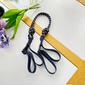 Detail of navy blue braided strap with golden accents and black plastic adjustment buckle - Navy Blue Shoulder Strap