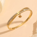 Detail of gold heart charm on curved bracelet with sparkling pave crystal settings - Gold Crossed Heart Pendant Style (H818)