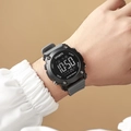 Close-up of a digital sports watch with matte black bezel and grey silicone strap - Gray