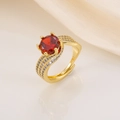 Macro shot of an adjustable gold ring featuring a large red zircon and white side stones - Gold Red