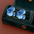 Macro shot of blue flower earrings with marble texture petals and gold trim - Blue Petals (Silver Pin)