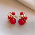 Pendientes de flor bañados en oro de 18k con cuentas rojas y brillantes circonitas - Base Dorada Perla Roja