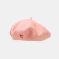 Close-up of pink wool beret featuring delicate red heart embroidery and soft texture - Pink