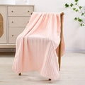 Pink coral fleece towel with vertical stripes draped over a wooden chair back - Bath Towel (70x140cm) / Pink